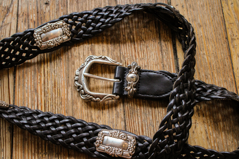 woven black leather belt with silver hardware details